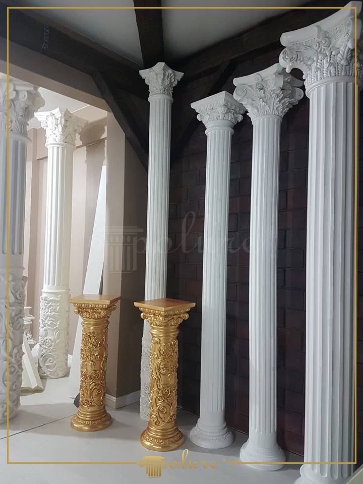 Coloane Decorative din Poliuretan și Postamente Aurii Coloana din poliuretan este un element decorativ arhitectural utilizat pentru a aduce o notă clasică și structură vizuală spațiilor interioare rezidențiale. În locuința noastră, colțul zonei de zi s-a transformat dintr-un simplu spațiu de trecere într-un punct central plin de căldură și rafinament. Am ales să combinăm textura pereților în nuanțe închise cu albul imaculat al coloanelor striate, creând un spațiu primitor în care familia și oaspeții se simt conectați la o atmosferă senină. Structura din poliuretan cu o densitate ridicată de 150-220 kg/m³ (țintă ~160 kg/m³) oferă o rezistență excelentă la impactul zilnic, păstrându-și aspectul impecabil de-a lungul anilor.
Fiecare dimineață devine mai plăcută atunci când lumina naturală pătrunde în hol și scoate în evidență detaliile sculptate ale capitulurilor corintice. Modelele de coloane precum P5520, P5540 și P5820 adaugă verticalitate livingului, oferind impresia unui tavan mai înalt și a unei încăperi mult mai aerisite. Copiii admiră adesea jocul delicat de umbre și lumini de pe canelurile verticale, iar cadrul general oferă acel sentiment confortabil de „acasă” de care ne bucurăm la fiecare revenire seara.
Pentru a oferi un plus de personalitate și strălucire, am adăugat două postamente elegante finisate în nuanțe aurii, realizate tot din polimer de înaltă calitate. Modelele P5830, P5840 și P5920C pun în valoare detaliile vegetale sofisticate ale frunzelor de acant. Materialul utilizat are un coeficient de absorbție a apei de sub 1%, ceea ce înseamnă că finisajele nu sunt afectate de umiditate, iar curățarea suprafețelor aurite se face extrem de ușor, doar cu o lavetă moale din microfibră. Datorită toleranței termice cuprinse între -100 °C / +80 °C, coloanele își păstrează stabilitatea dimensională indiferent de sezon.
Integrarea acestor elemente arhitecturale în casa noastră a fost o decizie minunată pentru întreaga familie, aducând acel echilibru între estetica tradițională și confortul modern. Coloanele nu doar că maschează discret eventuale treceri structurale, dar creează un fundal ideal pentru momentele festive petrecute alături de cei dragi. Este locul perfect unde plasăm aranjamente florale de sărbători sau obiecte dragi de familie, transformând un spațiu obișnuit într-o poveste vizuală plină de căldură.